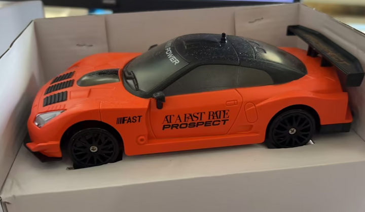 Czerwone auto do driftu z pachołkami